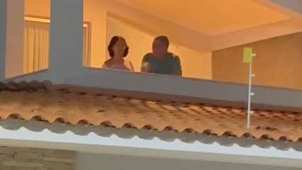 Students wave back at the woman with Alzheimer's disease who watches daily from balcony