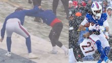 Bills players wrestling on the field in the downpour of snow in Buffalo