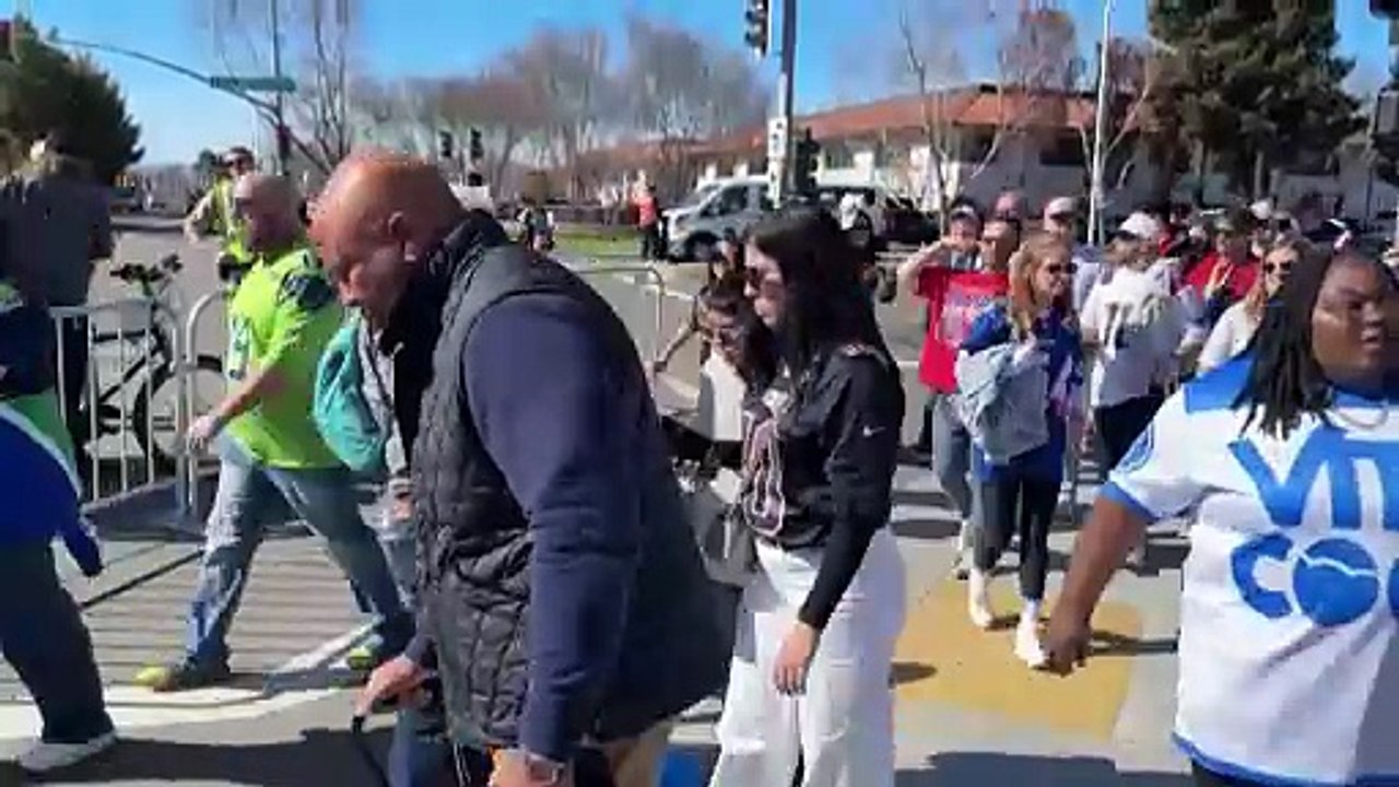 Activists distribute ‘ICE OUT’ towels at the Super Bowl