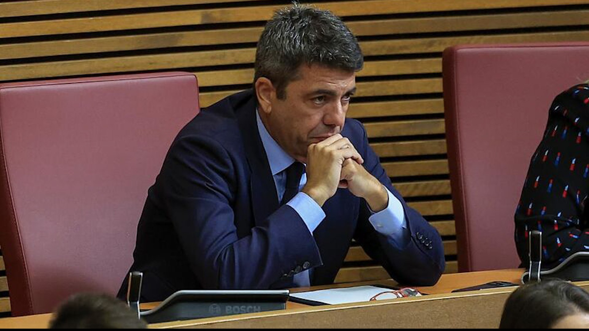 El avance de la investigaci�n judicial sobre la gesti�n de la cat�strofe que el pasado 29 de octubre seg� la vida de 230 personas en Valencia ha arrojado luz sobre la controvertida agenda de Carlos Maz�n. Este lunes, los tres escoltas que acompa�aron al entonces presidente de la Generalitat han comparecido como testigos ante la jueza de Catarroja, Nuria Ruiz Tobarra, aportando detalles cruciales sobre los movimientos del exjefe del Consell durante las horas cr�ticas de la emergencia.
Seg�n los testimonios recogidos en sede judicial, la jornada del 29 de octubre transcurri�, en sus primeras horas, con una aparente normalidad ajena a la gravedad meteorol�gica que se avecinaba. Uno de los agentes ha ratificado que durante la ma�ana no oy� "nada de la emergencia" o "nada sobre la emergencia" mientras cumpl�an con actos oficiales en la avenida de Catalu�a y el Palau de la Generalitat.
La revelaci�n m�s significativa de los escoltas se centra en el pol�mico almuerzo de Maz�n con la periodista Maribel Vilaplana en el restaurante El Ventorro. Los agentes han asegurado a la magistrada que la cita estaba se�alada en la "agenda privada" del ex &lsquo;president&rsquo; "desde el d�a anterior". A pesar de los avisos que ya circulaban, los testigos han subrayado que "en ning�n momento se coment� nada de suspender esa comida por la situaci�n". Al terminar la actividad matutina, el grupo se dirigi� a pie "hacia la comida de Maz�n" en el c�ntrico local de la calle Bonaire.
Uno de los momentos de mayor incertidumbre ocurri� justo antes de llegar al restaurante. Seg�n el relato de un escolta, "el presidente nos despide y dice que nos vayamos". Aunque el agente ha reconocido ante la jueza que "era raro que prescindiera de nuestros servicios antes de llegar a pie al restaurante, pero no era la primera vez". En ese imp�s, el equipo de seguridad regres� al Palau, ya que el presidente "no nos manda a casa, no da por terminada la jornada porque nos manda al Palau".
El vac�o de informaci�n sobre el paradero de Maz�n se prolong� durante horas hasta su regreso a la sede de la Generalitat. El primer escolta en declarar ha detallado que Maz�n lleg� al Palau sobre las 19:50 horas. En un breve encuentro, el exjefe del Consell les traslad�: "Ahora bajo y nos vamos". Apenas diez minutos despu�s, la comitiva parti� hacia L&rsquo;Eliana, recogiendo en el camino a la jefa de prensa, para llegar finalmente al Centro de Coordinaci�n de Emergencias sobre las 20:30 horas.
La jueza busca ahora determinar si los escoltas, que se coordinaban mediante un grupo de WhatsApp llamado "din�mica", escucharon alguna conversaci�n relevante entre Maz�n y la exconsellera Salom� Pradas, actualmente investigada junto a Emilio Arg�eso por su gesti�n del desastre.