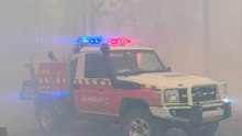 Australian bushfires raze homes in two states; firefighter dies