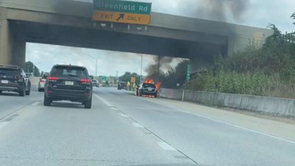 Distressing sight on freeway as car burns uncontrollably while passing drivers look on