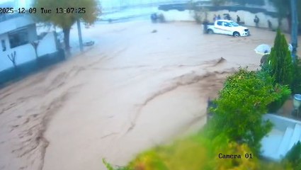 Children rescued seconds before school wall collapses on top of them as flash floods slam Iraq
