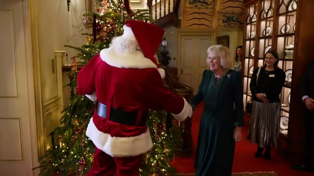 Queen Camilla greets Santa Claus during Christmas party