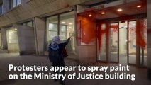Protesters appear to spray red paint on Ministry of Justice building