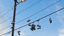 The Real Reasons You Sometimes See Shoes Dangling From Power Lines