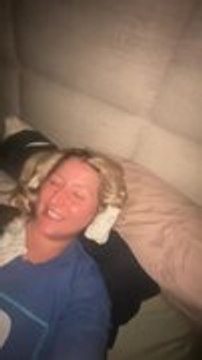 Dog Tries to Pull Socks Out of Woman's Hairdo