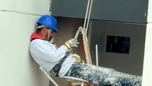 High-Rise Painter Takes a Break... Mid-Air! (Focuses on the job and the unexpected rest)