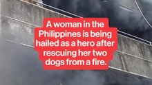 A woman in the Philippines is being hailed as a hero after rescuing her two dogs from a fire.