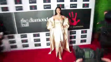 Rihanna Stuns In Orange Silk Dress As She’s Named A ‘National Hero’ In Barbados