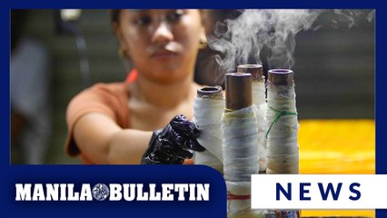Vendor prepares bibingka, puto bumbong at a stall near Quiapo Church in Manila
