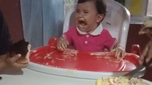 Toddler becomes overprotective of cake during her first birthday celebration