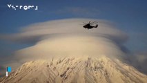A large lenticular cloud covers one of the volcanoes in Kamchatka, Russia