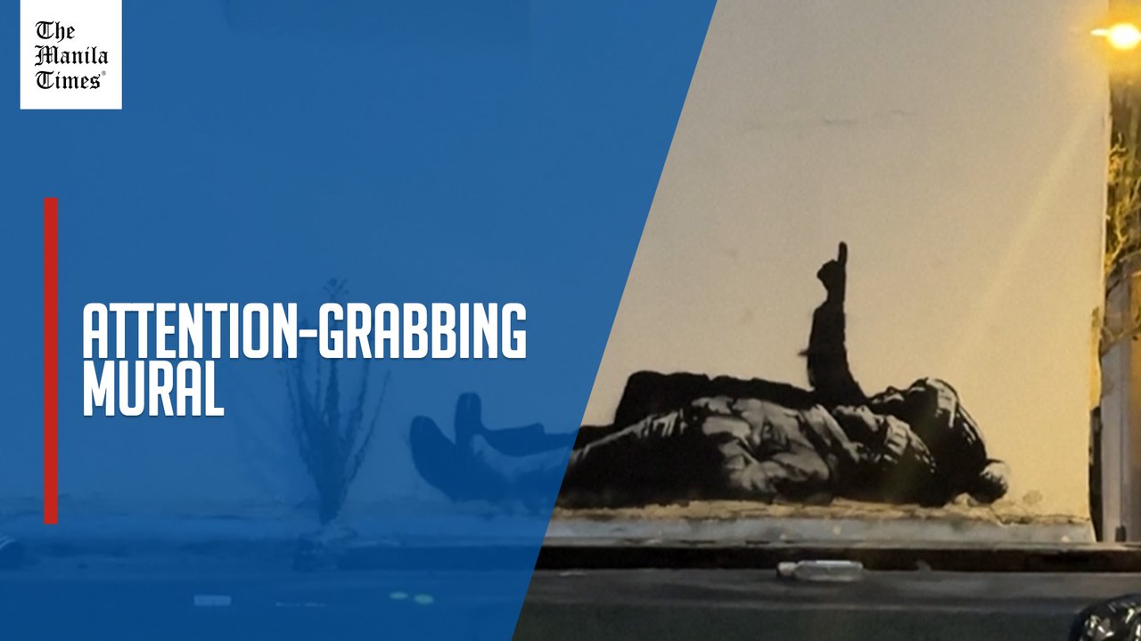 New Banksy artwork in London shows two children lying on ground, one pointing skyward