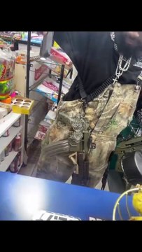 Tennessee man walks into a convenience store carrying multiple loaded guns, including two Kel-Tec PLR-16 pistols, one with a drum magazine and another with a 60-round magazine, plus additional handguns.