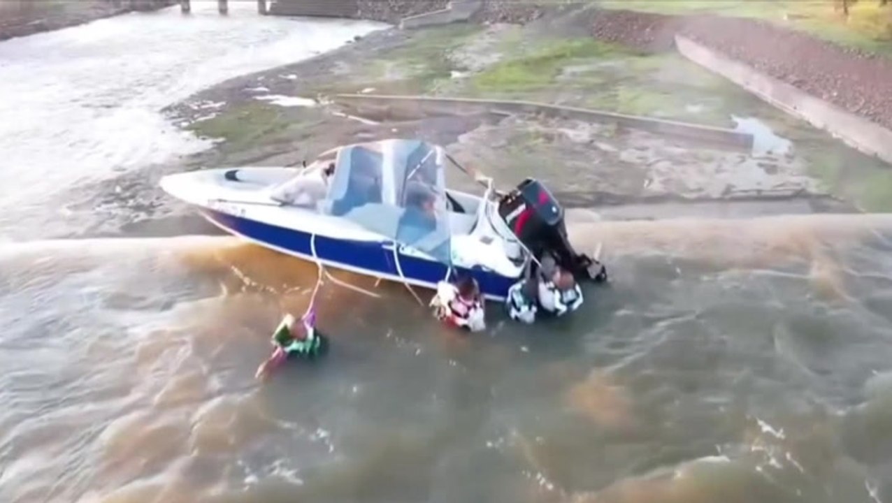 Watch: Men clinging to boat dangling over edge of 130ft dam saved by ...