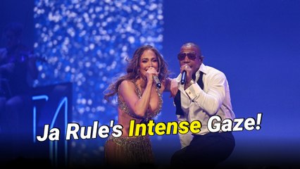 Ja Rule leans behind Jennifer Lopez and stares at her shaking her backside during their “Ain’t It Funny” performance in Las Vegas