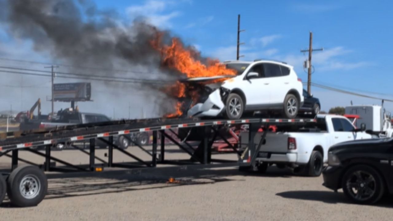 Dramatic footage shows a car engulfed in flames outside an auto auction facility