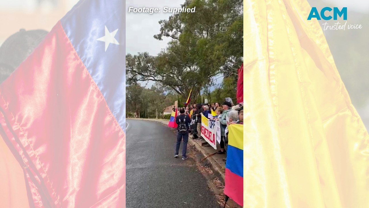 Protesters gather outside the US embassy in Canberra.