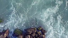 mixkit-overhead-view-of-a-rocky-coast-and-waves-crashing-51502-hd-ready (2)