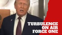 Donald Trump steadies himself during turbulence aboard Air Force One