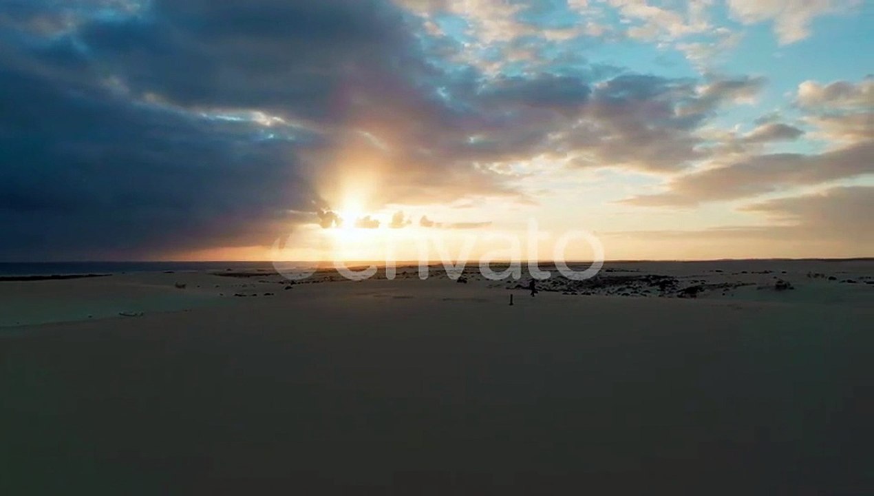 Desert Landscape with Walking Silhouette at Sunset