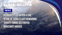 Residents flee after a fire in one of Seoul's last-remaining shanty towns destroyed makeshift houses