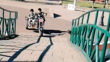 Daredevils take a motorbike sidecar over a ramp and end in a fall