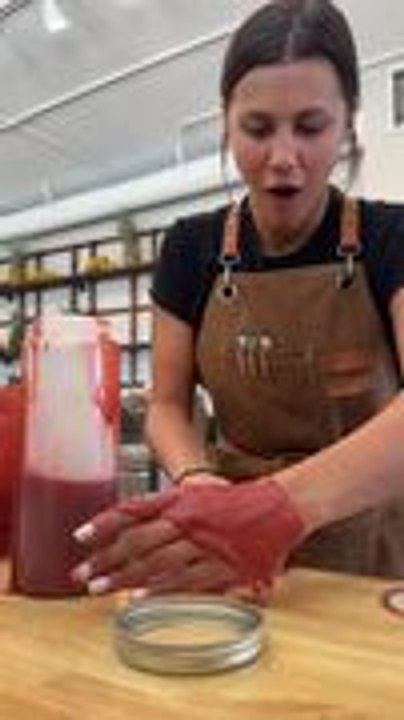 Woman Spills Syrup on Her Hand While Pouring It Into Bottle