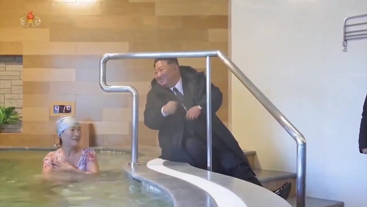 Kim Jong Un wears heavy winter coat and chats to swimsuit-clad women during tour of North Korean spa