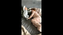 Infant’s sudden movement surprises toddler during playful moment in Charlotte, North Carolina, USA