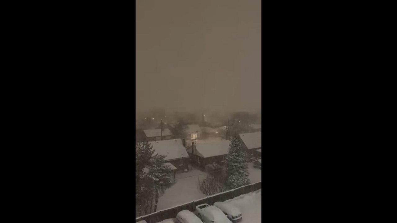 Heavy nighttime snowfall blankets neighborhood during blizzard in Hamilton, Ontario, Canada