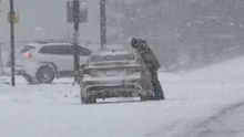 Driver struggles with wiper during heavy snowstorm in Rochester, New York, USA