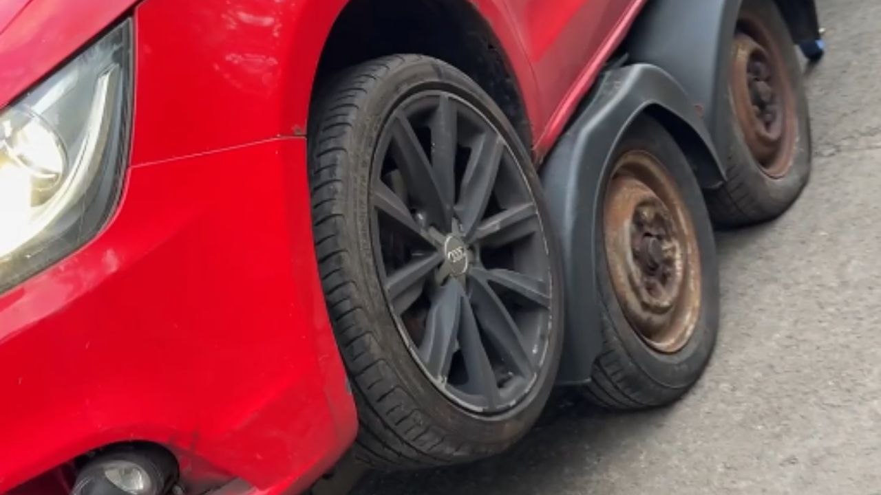 Red car ends up perched on trailer wheel arch after failed ramp try