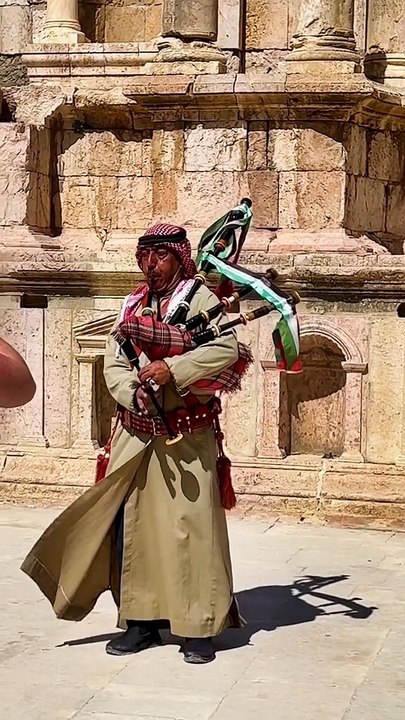 A Jordanian in a traditional keffiyeh playing the bagpipes among the ruins in Jerash 🇯🇴💙 #bagpipes