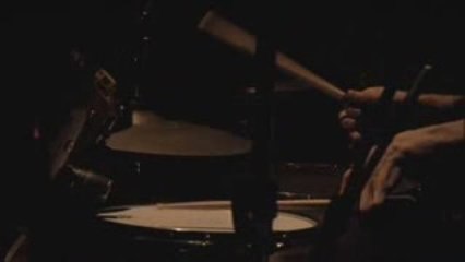 Kai is playing the drums