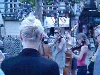 (clichéd) music playing in the street by the Louvre.