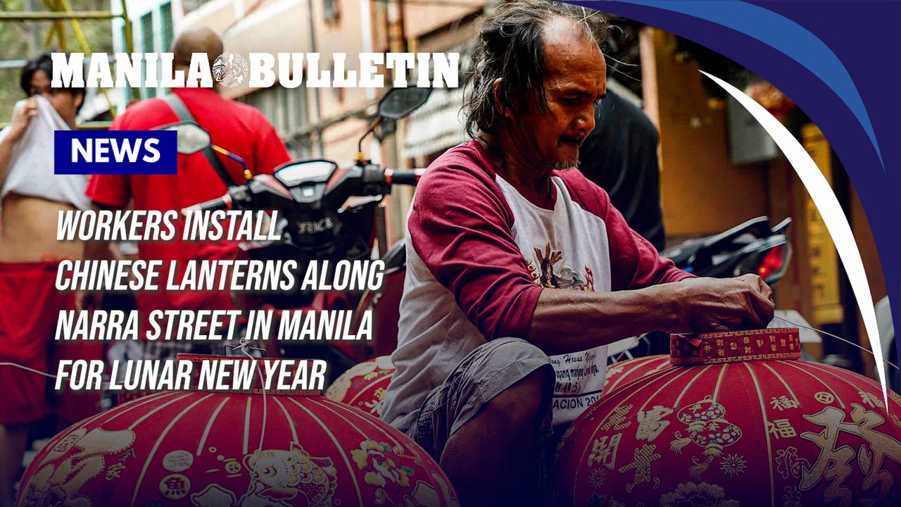 Workers install Chinese lanterns along Narra Street in Manila for Lunar New Year