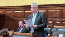 Treasury Minister Chris Thomas MHK delivers his budget speech against a background of unprecedented political drama