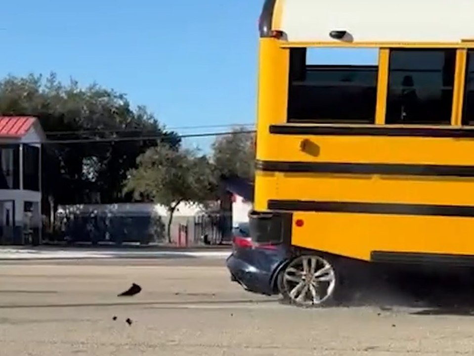 Auto kracht in Schulbus und bleibt darunter stecken