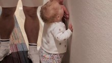 Toddler gives silly thoughts a chance and decides to lick the wall of hotel