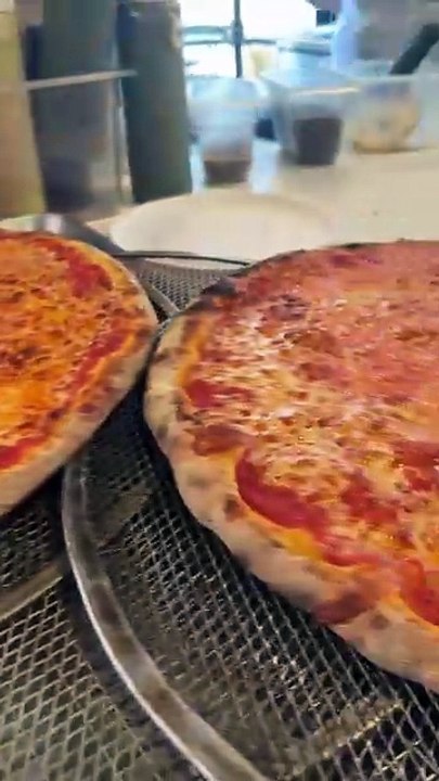 2 cheese pizzas fresh out of the oven!