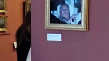 Activists literally hang Prince Andrew arrest photo inside Louvre