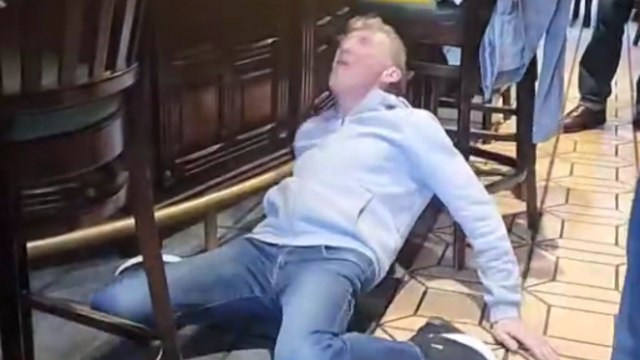Man attempts a bold party trick in a pub by jumping from a stool and doing a scary landing