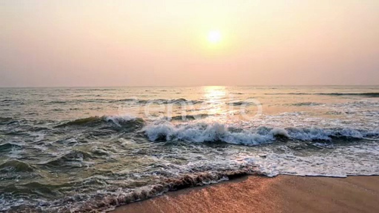 Slow Motion of Tropical Sea Waves Breaking on Empty Sandy Tropical Beach at Evening Sun