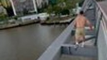 Parkour Athlete Jumps and Runs Across Top of Bridge in Brisbane, Australia