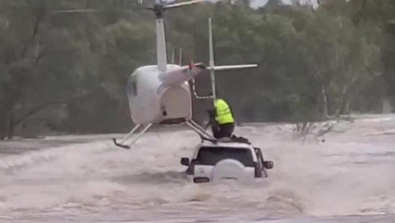 Moment dog is rescued from raging floodwaters by helicopter