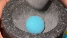 Amazingly satisfying scene of a bright blue bath bomb being pulverized