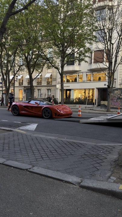 A $3 million hypercar being loaded onto a specialized transporter, demanding millimeter precision