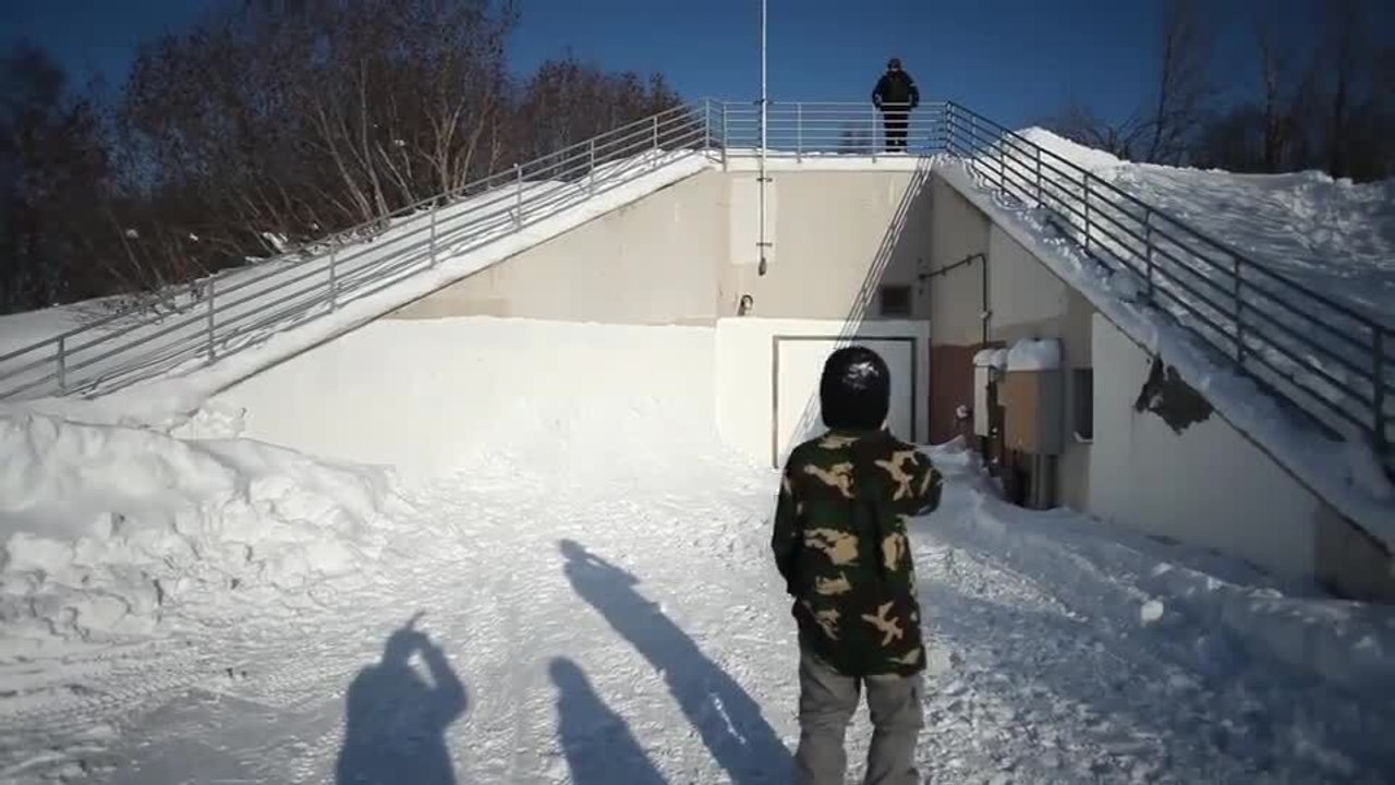 Snowboarder Attempts Jump and Falls